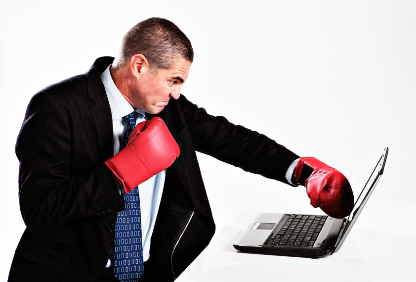 Man punching laptop